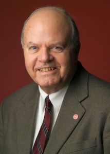 Professional headshot in suit and tie.