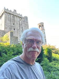 Tom Fox standing outside with a Gothic building behind him.