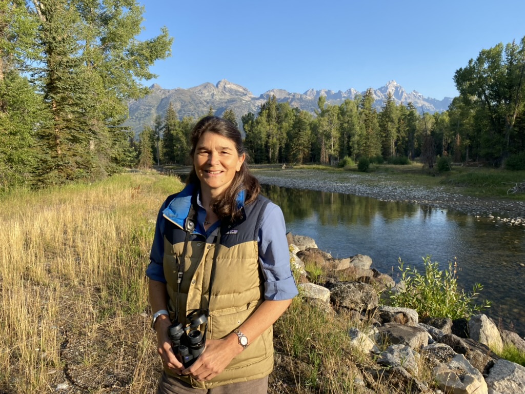 Wide shot of Sally Gibbons outdoors on a sunny day stranding near a creek