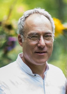 Outdoor portrait of Jonathan Miller who is smiling and facing the camera 