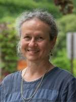 Outdoor portrait of Rebecca Nelson who is smiling and facing the camera at an angle